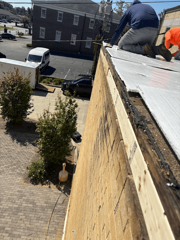 People working on a commercial roof
