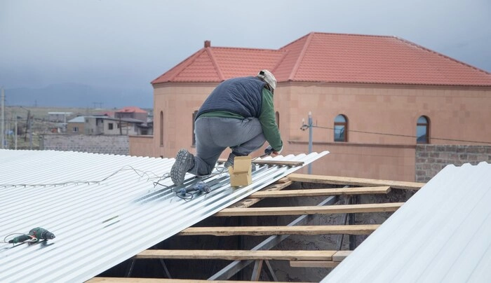 A man doing work on a commercial roof