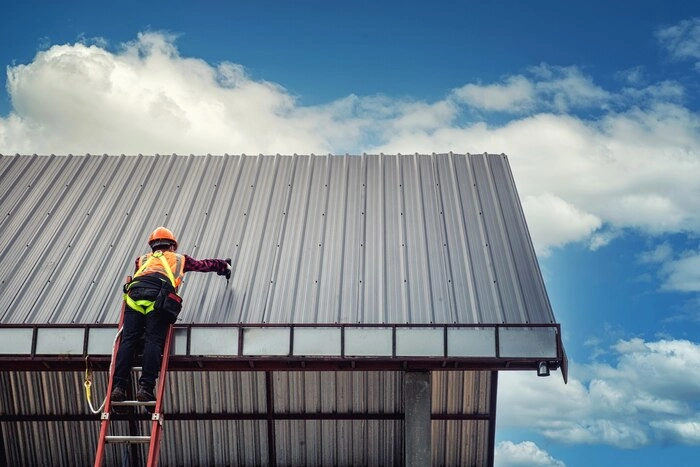 A man working on a metal roof