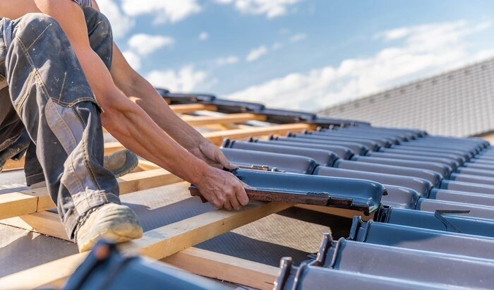 A man installing a roof