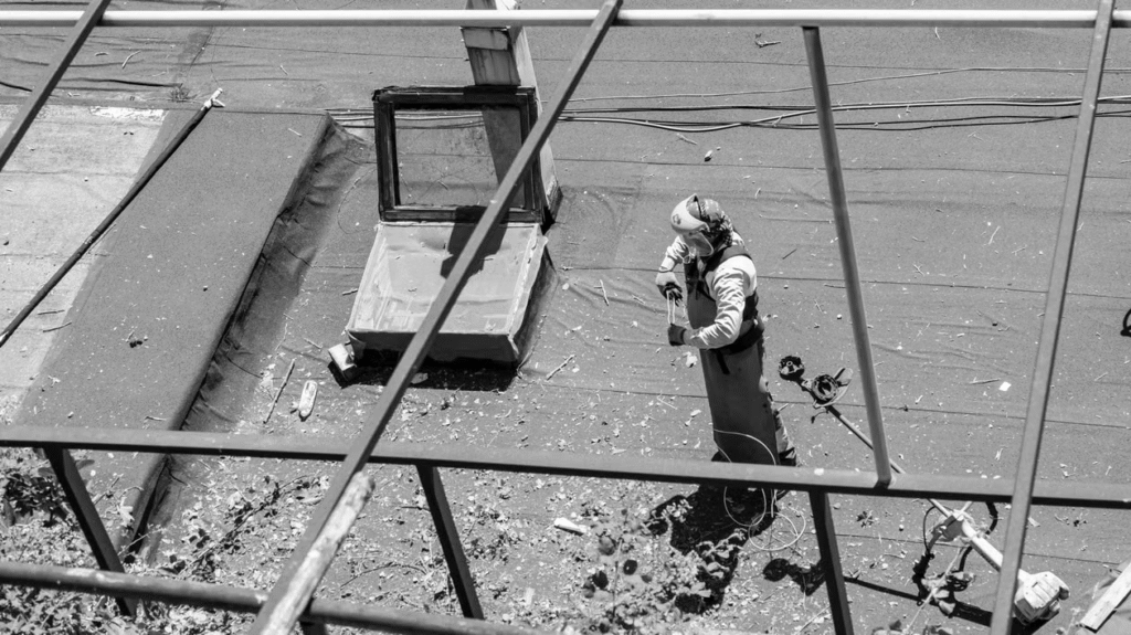 aerial view of a man working on top of a roof