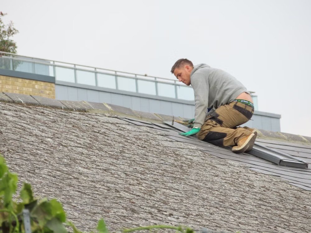 a handyman working on a rooftop