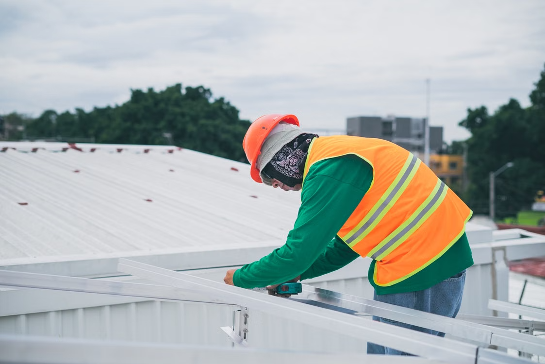 a man working on top of a roof