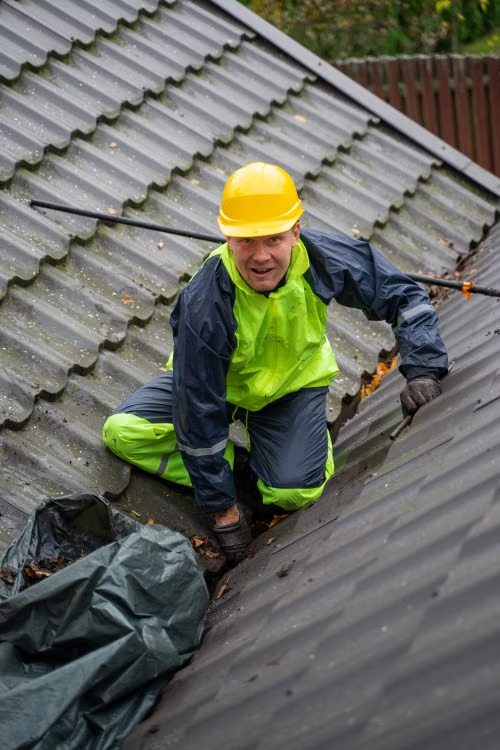 a worker inspecting the roof