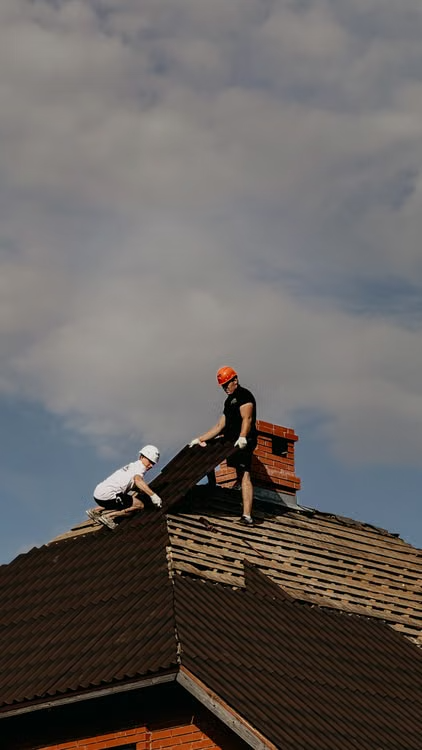 men working on top of a roof