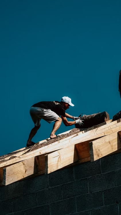 a man working on top of a roof